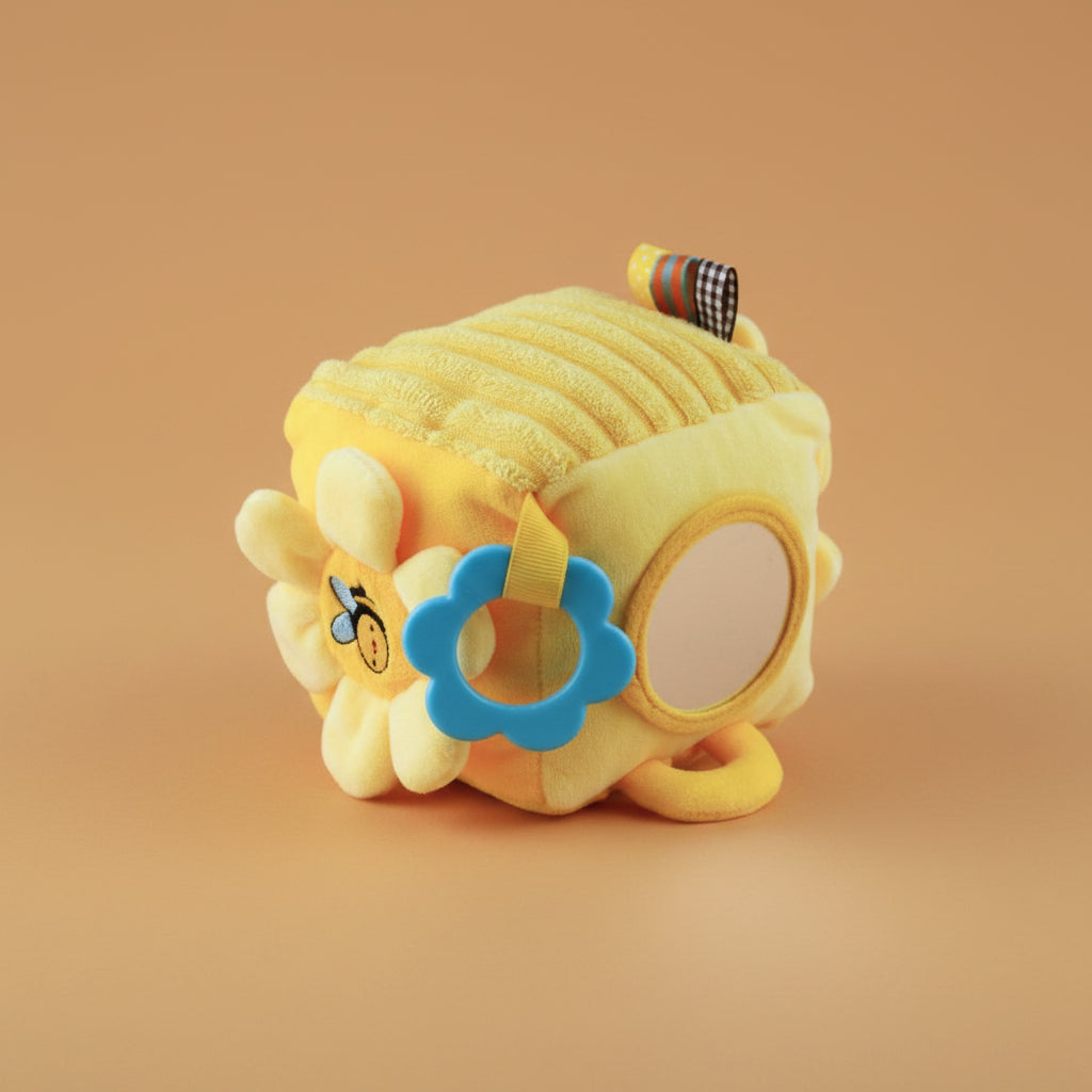 Yellow plush toy with a blue flower on a warm caramel background