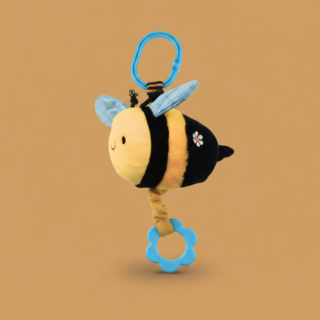 Plush bee toy with a blue handle on a warm caramel background