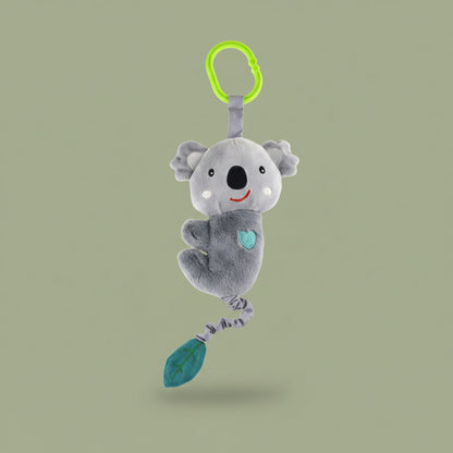 Plush koala toy with a green leaf and green ring on a olive-green background