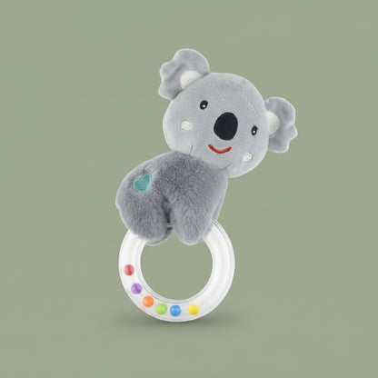 Plush koala toy with a ring and colourful beads on a olive-green background.