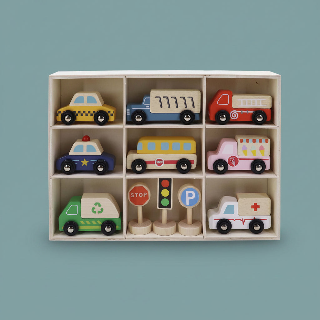 Set of colorful toy vehicles and traffic signs on a teal-blue background